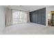 Spacious bedroom with large arched window, grey accent wall, and plush carpeting at 8921 Greenridge Way, Indianapolis, IN 46278