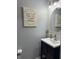 Clean bathroom with a vanity, mirror, and unique wall art at 10048 New Dawn Pl, Avon, IN 46123