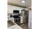Modern kitchen with white cabinets, marble countertops, and stainless steel appliances at 10048 New Dawn Pl, Avon, IN 46123