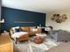 Modern living room with an L-shaped sectional sofa and accent chair at 10048 New Dawn Pl, Avon, IN 46123