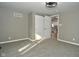 Bedroom with neutral decor, carpet flooring, and access to the kitchen at 11365 W State Road 142, Martinsville, IN 46151