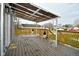 A covered deck with wood railings and potted plants provides an outdoor seating area at 11365 W State Road 142, Martinsville, IN 46151