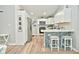Modern kitchen with white cabinets, stainless steel appliances, and a breakfast bar at 11365 W State Road 142, Martinsville, IN 46151