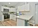 White kitchen with stainless steel appliances and an island with seating at 11365 W State Road 142, Martinsville, IN 46151