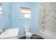 Light blue bathroom with white bathtub and marble-style shower at 117 W 36Th St, Indianapolis, IN 46208