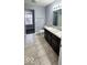 Bathroom with double vanity, toilet and access to closet at 3801 Boundary Bay Dr, Indianapolis, IN 46217