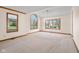 Dining room with large windows and neutral carpeting at 5059 Countess Dr, Columbus, IN 47203