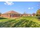 Brick ranch home with a backyard and patio at 5059 Countess Dr, Columbus, IN 47203