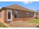 Brick ranch house with a patio and yard at 5059 Countess Dr, Columbus, IN 47203