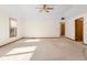 Spacious living room featuring wall-to-wall carpet and a ceiling fan at 5059 Countess Dr, Columbus, IN 47203