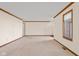 Large living room with neutral carpeting and ample natural light at 5059 Countess Dr, Columbus, IN 47203