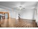Open living room with hardwood floors, kitchen view, and ceiling fan at 6005 S Darlington Rd, Jamestown, IN 46147