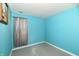 Simple bedroom with teal walls and gray carpeting at 11218 Boston Way, Fishers, IN 46038