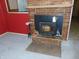 Brick fireplace with wood-burning stove at 137 E Vine St, Jamestown, IN 46147