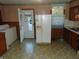 Kitchen with wood cabinets, appliances, and laundry area at 137 E Vine St, Jamestown, IN 46147