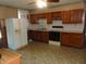 Galley kitchen with wood cabinets and appliances at 137 E Vine St, Jamestown, IN 46147