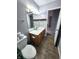 Bathroom boasts a vanity with white countertop and grey tile floor at 1425 Lawrence Way, Anderson, IN 46013