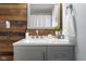 Gray bathroom vanity with quartz countertop and wood-paneled accent wall at 14313 S San Vincente Dr, Columbus, IN 47201