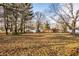 Large backyard with mature trees and a view of neighboring homes at 1820 Whittier Ave, Anderson, IN 46011