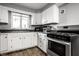 Kitchen with white cabinets, stainless steel appliances, and granite countertops at 1820 Whittier Ave, Anderson, IN 46011