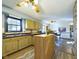 Kitchen features island, wood cabinets, and dining area view at 2879 S 380 E, Anderson, IN 46017