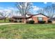 Brick ranch house with attached garage and landscaped yard at 295 N Restin Rd, Greenwood, IN 46142