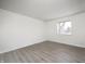 Bright bedroom with light gray wood-look floors and window at 305 Elmead Ct # 3012, Greenwood, IN 46142