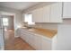 Kitchen with white cabinets and wood countertops at 3106 N Sherman Dr, Indianapolis, IN 46218