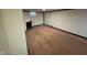 Unfinished basement with carpeted floor and fireplace at 3407 Harvest Ave, Indianapolis, IN 46226