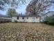 Back of the house showing a yard covered in autumn leaves at 3407 Harvest Ave, Indianapolis, IN 46226