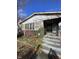 House exterior in need of renovation, showcasing front steps and porch at 3834 E 13Th St, Indianapolis, IN 46201