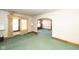 Living room with green carpet and an archway to the dining room at 4131 Otterbein Ave, Indianapolis, IN 46227