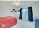 Bedroom with red bedding, large window, and blue curtains at 4223 Shine Ct, Carmel, IN 46033