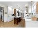 Modern kitchen with white and wood cabinets, a large island, and a farmhouse sink at 4351 Chase Cir, Zionsville, IN 46077