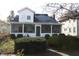 White house with screened porch, landscaping, and driveway at 439 Berkley Rd, Indianapolis, IN 46208