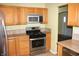 Kitchen with stainless steel appliances and wood cabinets at 439 Berkley Rd, Indianapolis, IN 46208