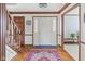 Spacious entry with hardwood floors, wooden staircase, and decorative rug at 4677 Bedford Ct, Carmel, IN 46033