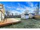 Deck with green chairs overlooking a spacious backyard with a shed at 469 Springdale Dr, Whiteland, IN 46184