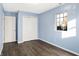 Light blue walls, wood-look floors, and a spacious closet in this bedroom at 469 Springdale Dr, Whiteland, IN 46184