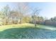 Landscaped backyard with mature trees and grassy area at 4770 Winterberry Pl, Columbus, IN 47201