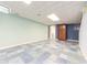 Finished basement offering versatile space with tile flooring and separate room at 4770 Winterberry Pl, Columbus, IN 47201