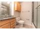 Clean bathroom with wood cabinets and shower at 4770 Winterberry Pl, Columbus, IN 47201