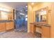 Luxurious bathroom featuring double vanities, granite countertops, and a walk-in shower at 4770 Winterberry Pl, Columbus, IN 47201