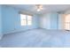 Light blue bedroom with carpet, ceiling fan, and window with natural light at 4770 Winterberry Pl, Columbus, IN 47201