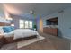 Primary bedroom with a wood platform bed and large windows at 4770 Winterberry Pl, Columbus, IN 47201