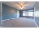 Spacious bedroom with light blue walls, carpet flooring, and ceiling fan at 4770 Winterberry Pl, Columbus, IN 47201