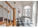 Checkerboard floor entryway with a grand staircase and arched glass front door at 4770 Winterberry Pl, Columbus, IN 47201