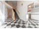 Spacious entryway with a checkerboard floor, a staircase, and views of the kitchen at 4770 Winterberry Pl, Columbus, IN 47201