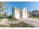 Side view of beige two-story house with three-car garage at 4770 Winterberry Pl, Columbus, IN 47201