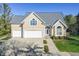 Two-story house with a beige exterior, grey roof, and a two-car garage at 4770 Winterberry Pl, Columbus, IN 47201